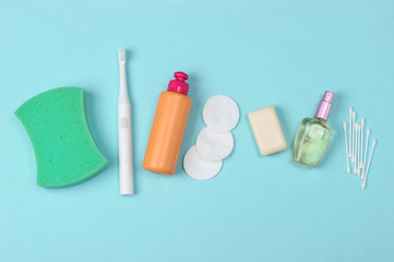 Fototapeta premium Beauty, health care, cosmetics, hygiene product on blue background. Flat lay. Top view