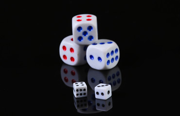 Dice on a black background with reflection. Fortune, gaming addiction