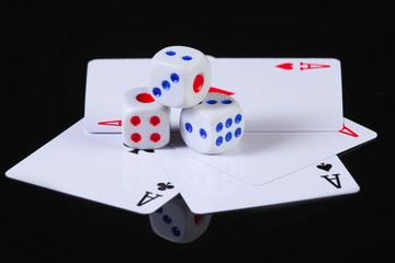 Dice with four aces on a black background.