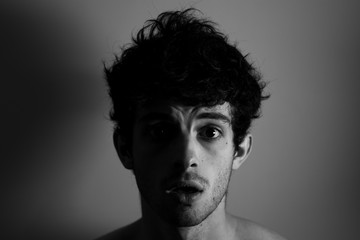 Cry shocked angry man curly hair shadows light black and white