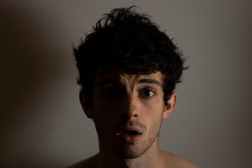 Cry shocked angry man curly hair shadows light black and white