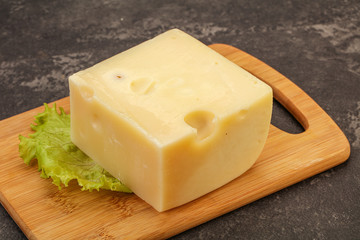 Emmental cheese over wooden board
