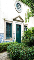 Fototapeta na wymiar old house with green ivy, heritage building in Macau, Portuguese colonial architecture