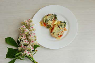 baked zucchini with vegetables on a white plate, for proper nutrition, 