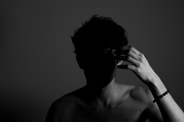 Young man teenager touching head hand curly hear