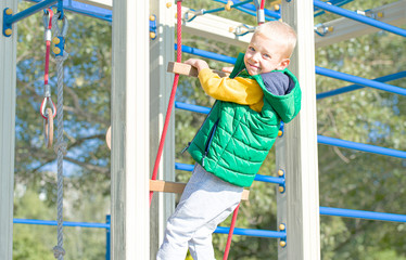 The child plays in the playground, climbs the stairs.