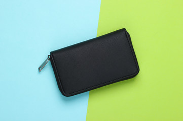 Black stylish wallet on green blue pastel background. Top view