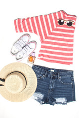 summer look. striped shirt , denim shorts , straw hat, sunglasses and gumshoes isolated on white.