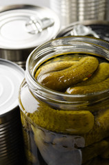 Canned pickles in just opened glass mason jar. Non-perishable food