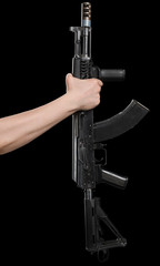 Kalashnikov assault rifle ak74 in male hand isolated on a black background