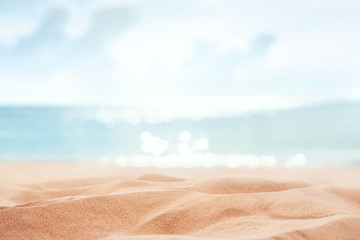 Fototapeta na wymiar Tropical summer sand beach and bokeh sun light on sea background, copy space.