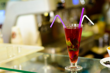 Pink cocktail with ice and mint, selective focus