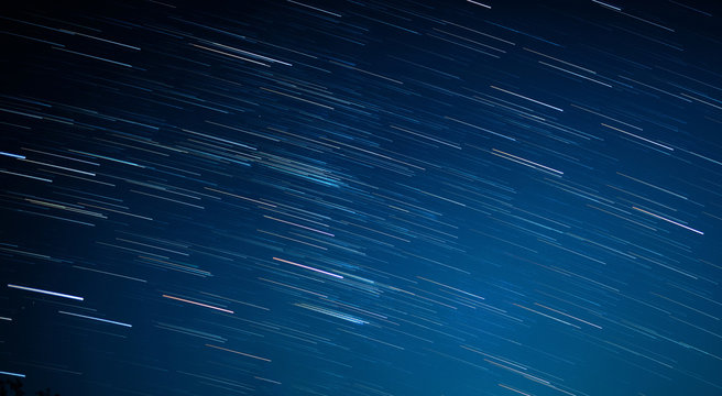startrails on a dark blue sky at night