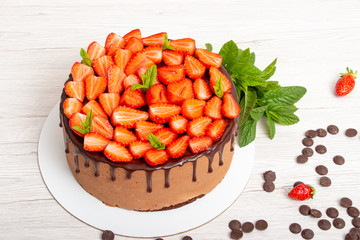 Mousse cake with profiteroles inside and strawberries
