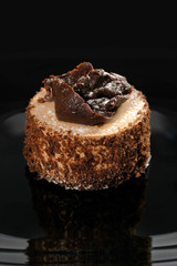 A piece of chocolate cake on a dark background, close-up.