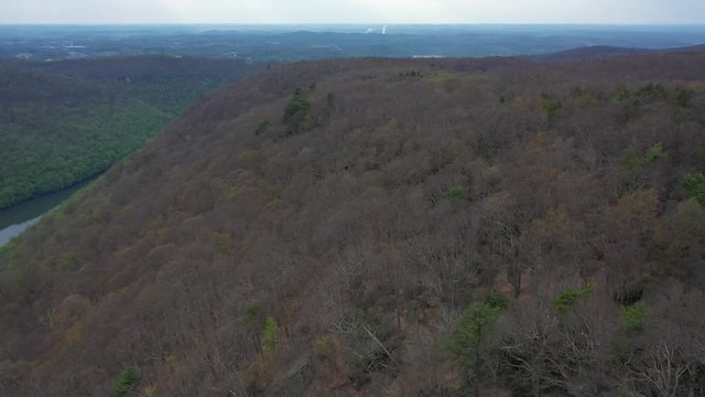 Aerial camera descending revealing the Coopers Rock overlook and its placement in the expansive forest and mountains.