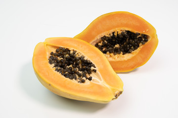 Papaya cut in half on white background.