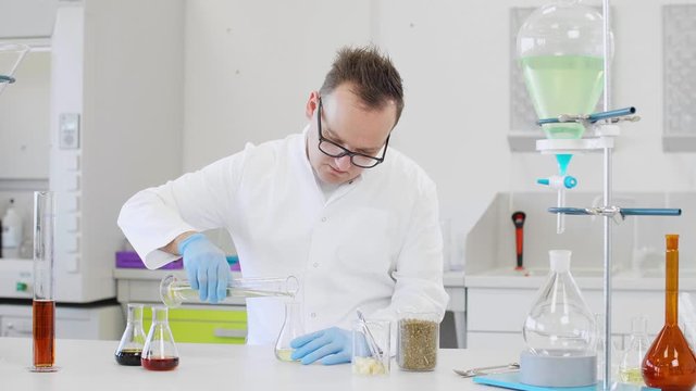 Chemist working with hemp CBD oil in laboratory