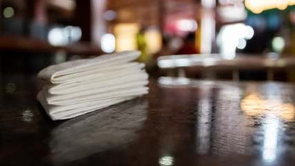 Bright low angle close up shot of tissue papers with bright light reflecting on the table for Table Etiquette concept.