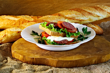 Juicy sandwich with sauce and herbs