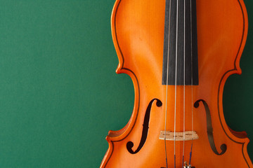 Classical music concert poster with brown color violin on dark green background with copy space for your text  © Mikalai