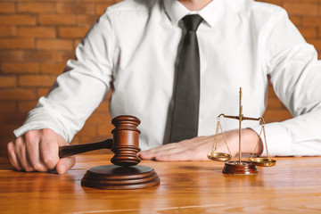 Male judge at table in courtroom, closeup