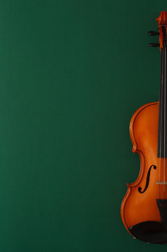 Classical music concert poster with brown color violin on dark green background with copy space for your text
