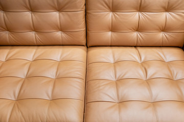 Vintage bumpy brown leather background sofa. Close up