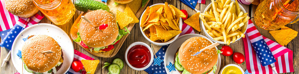 Celebrating Independence Day, July 4. Traditional American Memorial Day Patriotic Picnic with burgers,  french fries and snacks, Summer USA picnic and bbq concept, Old wooden background