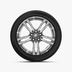 Obraz premium Front view of car wheel isolated on white. Modern car wheel on light alloy disc. Car tire Illustration. Automotive wheel with soft shadow.