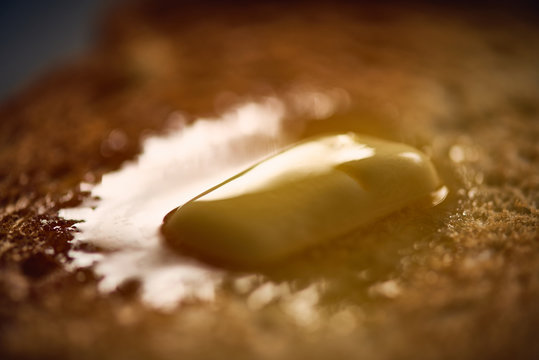 Extreme Close-up Of Butter Melting On Bread