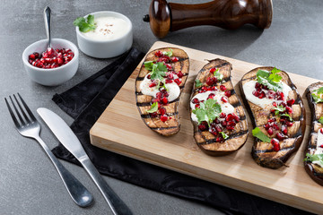 Eggplant with yorgut pomegranate seeds, nuts and parsley.