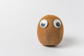 Cute kiwi character with Googly eyes on white background. Vegetarianism concept