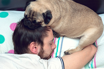 Man and his dog comfortably sleeping in