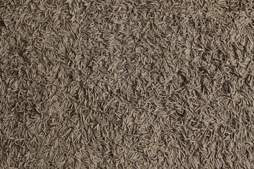 The texture formed by the fibers of the carpet as a background.