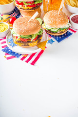 Celebrating Independence Day, July 4. Traditional American Memorial Day Patriotic Picnic with burgers, french fries and snacks, Summer USA picnic and bbq concept, White concrete background