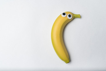 Banana with Googly eyes on white background. Banana character. Copy space