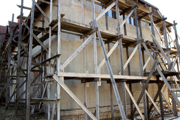 wooden scaffolding during the construction of a large house or cottage outside