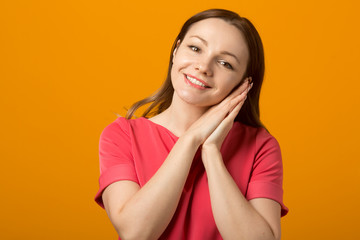 beautiful young woman in a pink dress on a yellow background	
