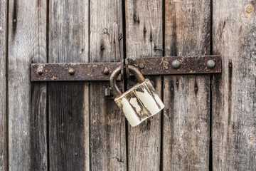Old metal lock on old wooden door
