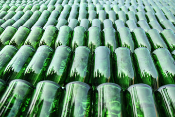 Many green bottles are arranged in straight rows. Empty bottles of wine, champagne on the full...