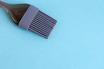 Cooking silicone brush on a blue background.