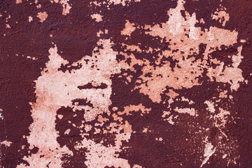 texture of a plastered wall with a partially maroon paint
