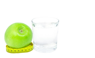 An apple and glass of a water, meter isolated on white