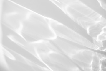 Obraz premium Water texture overlay effect for photo and mockups. Organic drop diagonal shadow and light caustic effect on a white wall. Shadows for natural light effects