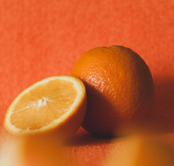 soft focus of whole and cut juicy organic tropical fruit on orange background