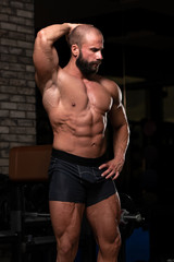 Obraz na płótnie Canvas Young Man Showing Abdominal Muscle