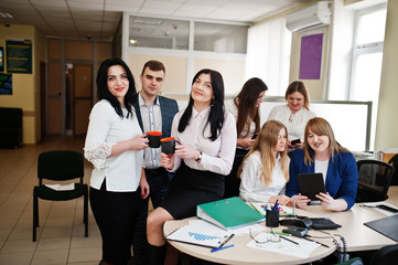 Young business people group of bank workers have meeting and working in modern office. Two female have coffe break with cup on hands.