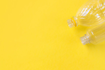 Plastic bottles top view on yellow background