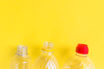 Plastic bottles top view on yellow background